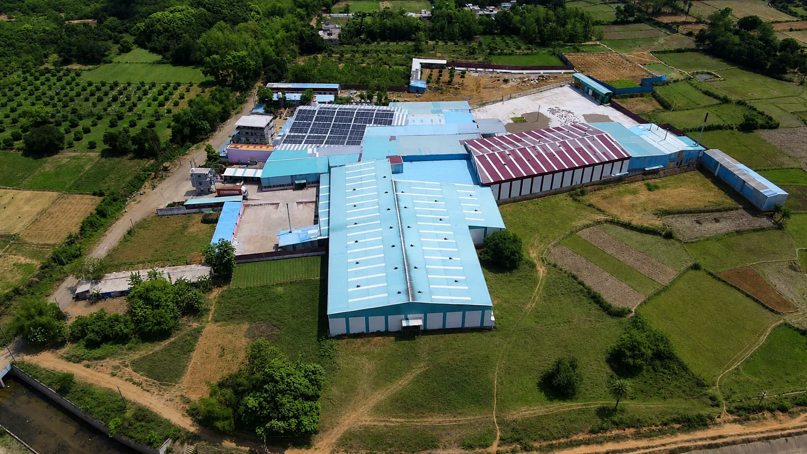 Wide aerial view of Satyam Enterprises cashew processing campus in Odisha